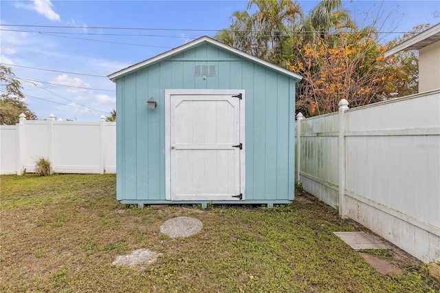 view of outbuilding featuring a yard