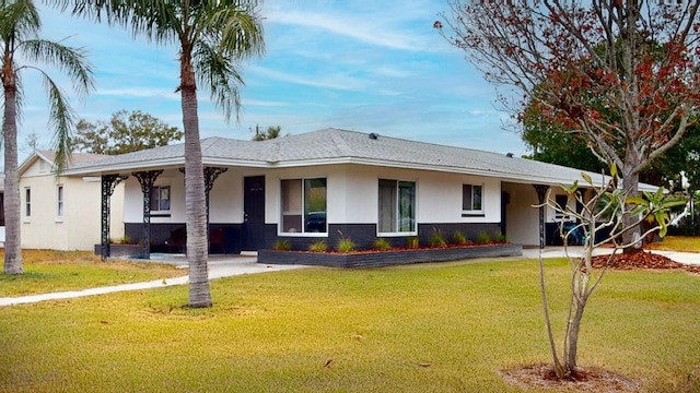 ranch-style home with a front lawn