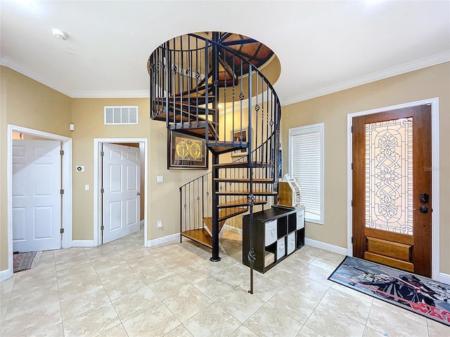 foyer featuring tile patterned floors and ornamental molding