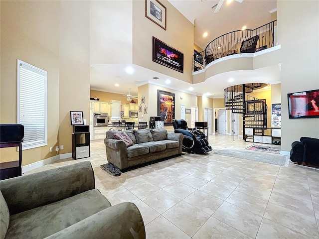 tiled living room featuring ornamental molding and a towering ceiling