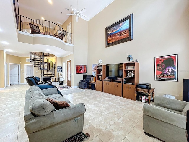 living room with ceiling fan, tile patterned floors, and a towering ceiling