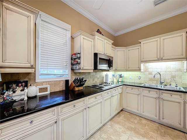 kitchen featuring light tile patterned floors, cream cabinetry, black electric cooktop, ornamental molding, and sink