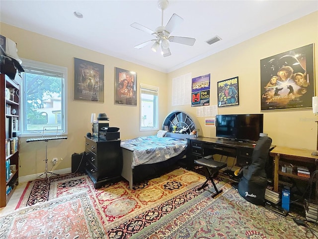 bedroom featuring ceiling fan and ornamental molding