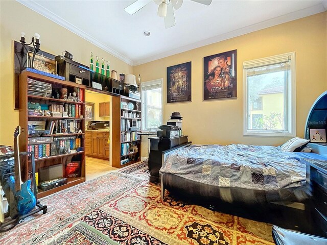 bedroom with ceiling fan, ensuite bathroom, and ornamental molding