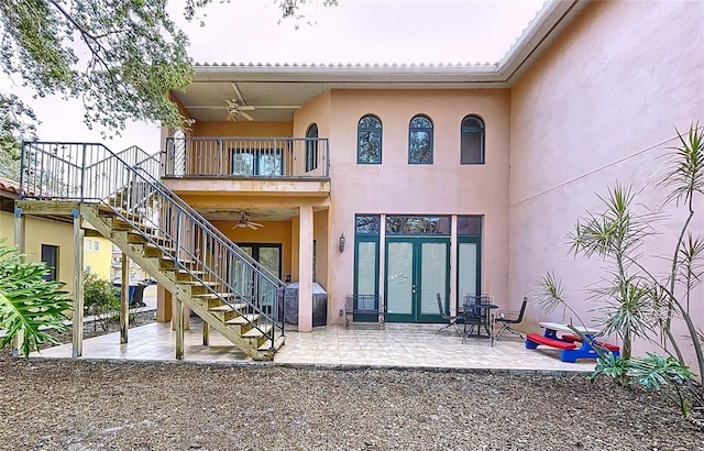 exterior space with ceiling fan, a patio area, french doors, and a balcony