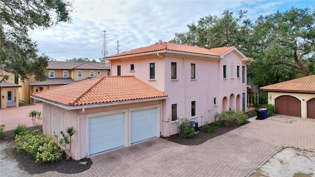 mediterranean / spanish-style home featuring a garage