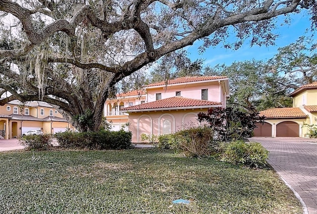 mediterranean / spanish-style home with a front yard