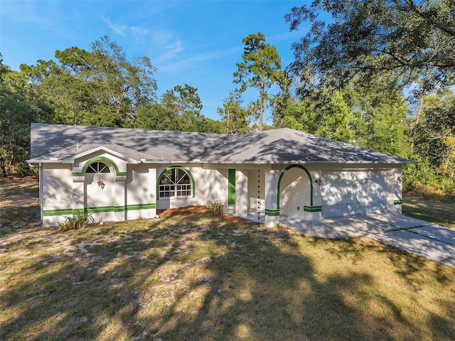 ranch-style home with a garage and a front yard