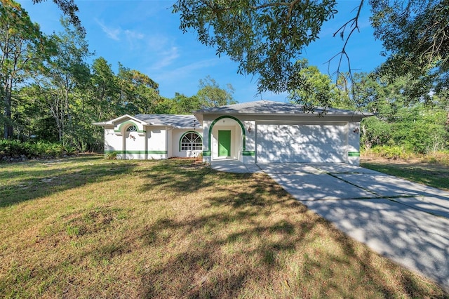 single story home featuring a garage and a front yard