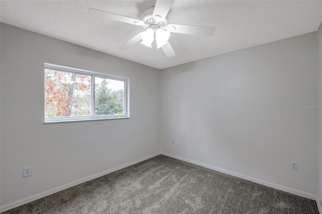 carpeted spare room with ceiling fan and a textured ceiling