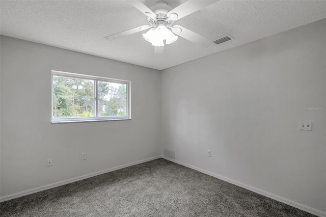 spare room featuring ceiling fan, carpet, and a textured ceiling