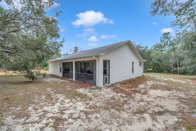 view of side of property featuring a sunroom