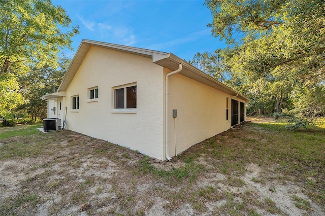 view of side of home featuring central AC unit