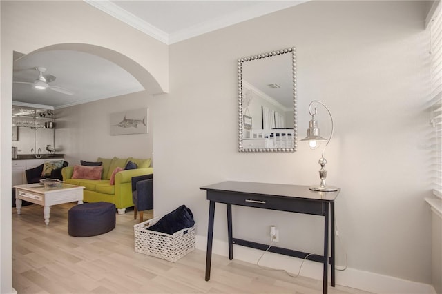 living room with crown molding, wood-type flooring, and ceiling fan