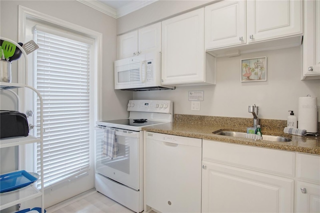 kitchen featuring white appliances, white cabinets, a wealth of natural light, sink, and ornamental molding