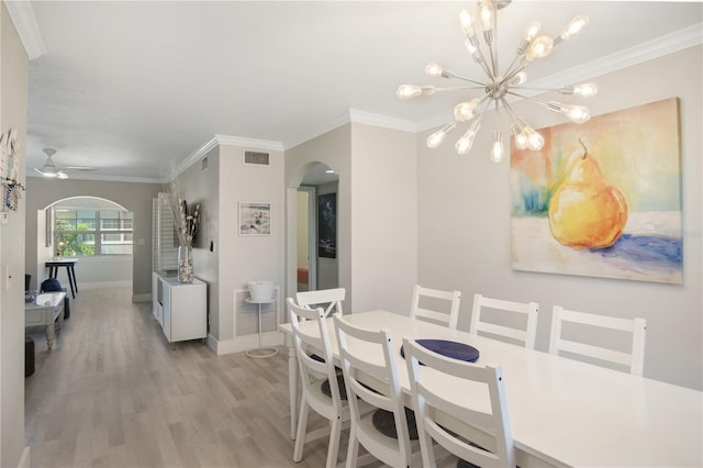 dining space featuring ceiling fan with notable chandelier, ornamental molding, and light hardwood / wood-style floors