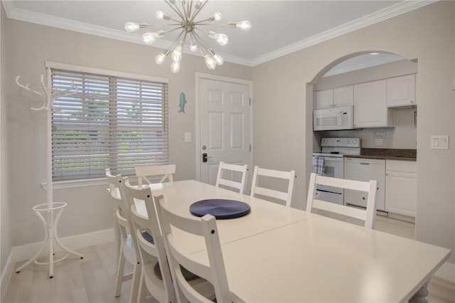 dining room with light wood-type flooring, a notable chandelier, and ornamental molding