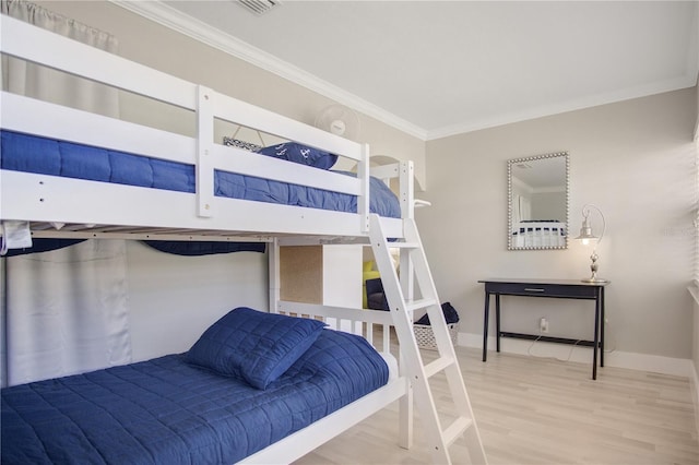 bedroom with crown molding and wood-type flooring