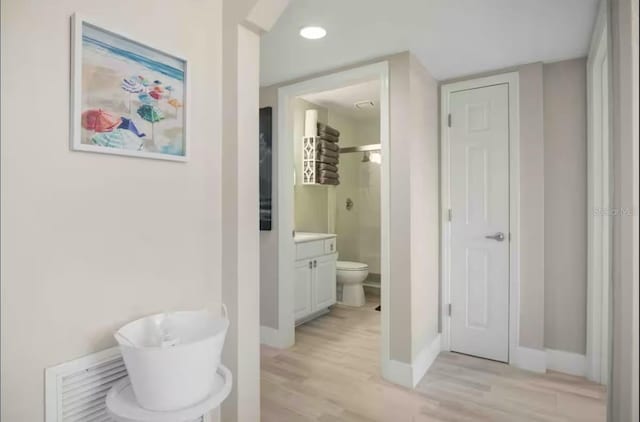 full bathroom with hardwood / wood-style flooring, toilet, vanity, and independent shower and bath