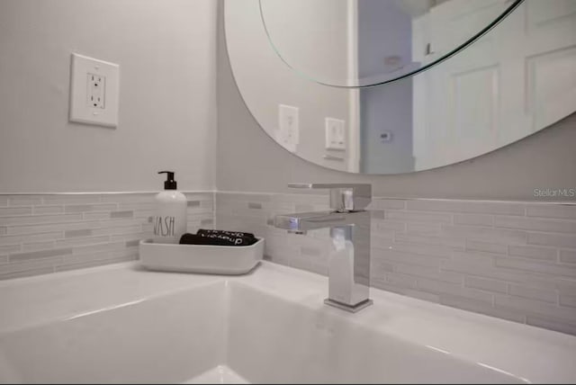 bathroom featuring sink and backsplash