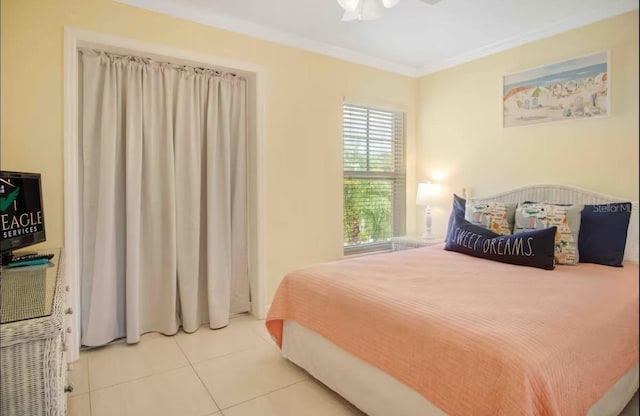 bedroom with ceiling fan, light tile patterned floors, and crown molding