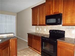 kitchen with black appliances and decorative backsplash