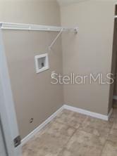 laundry area with tile patterned flooring and hookup for a washing machine