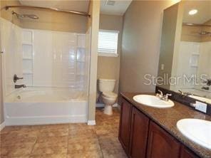 full bathroom featuring tile patterned floors, toilet, vanity, and shower / washtub combination