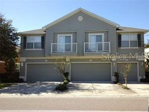 view of front facade with a garage and a balcony