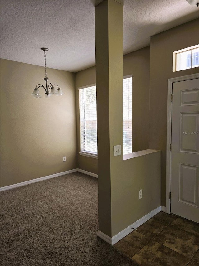 6769 Breezy Palm Dr, Riverview, FL 33578 - foyer with plenty of natural light, a textured ceiling, a chandelier, and baseboards