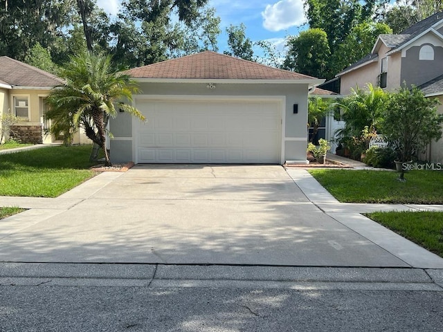 view of front of house featuring a front yard and a garage