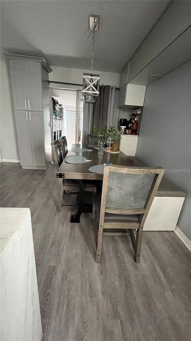 dining room with dark hardwood / wood-style flooring