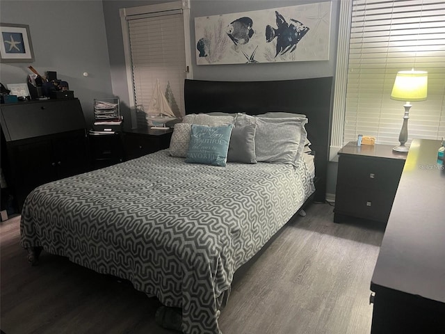 bedroom with hardwood / wood-style flooring