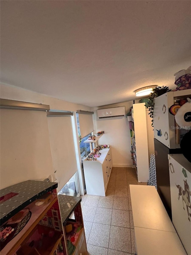 kitchen with an AC wall unit and white cabinets