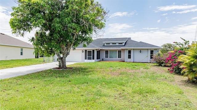 view of front of home with a front yard and a garage