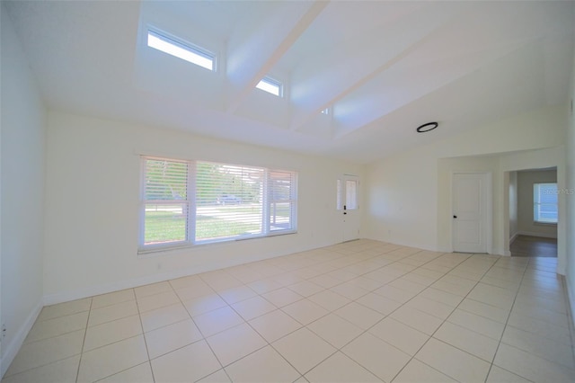 tiled spare room featuring a high ceiling