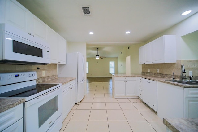 kitchen with white appliances, white cabinetry, sink, kitchen peninsula, and ceiling fan