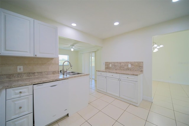 kitchen with ceiling fan with notable chandelier, white cabinets, sink, backsplash, and white dishwasher