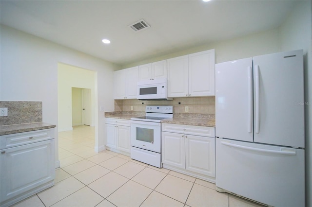 kitchen featuring light tile patterned floors, decorative backsplash, white appliances, and white cabinetry