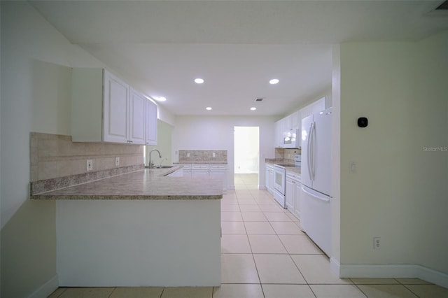 kitchen featuring white appliances, white cabinets, decorative backsplash, sink, and kitchen peninsula