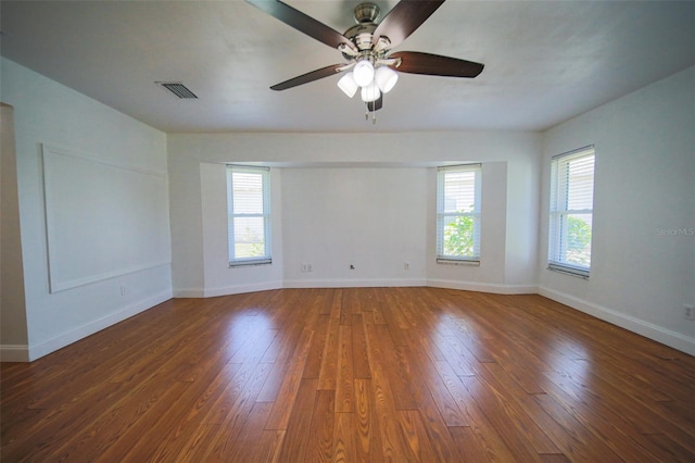 unfurnished room featuring ceiling fan and dark hardwood / wood-style flooring