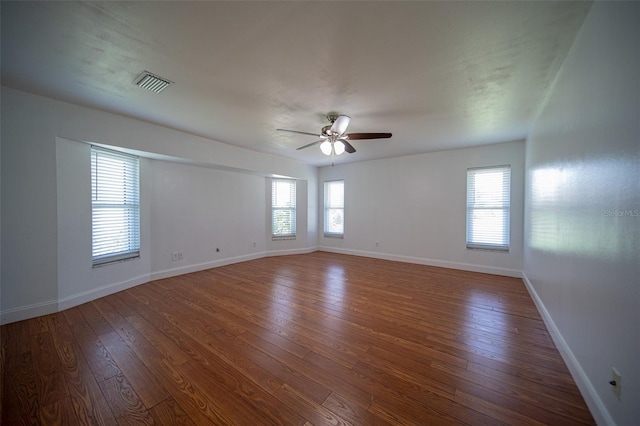 spare room with ceiling fan and dark wood-type flooring