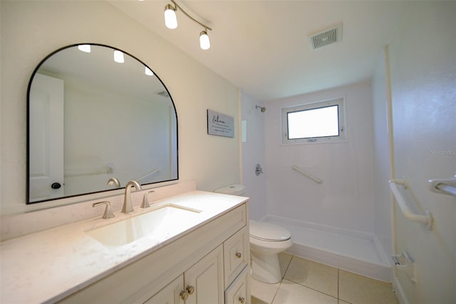 bathroom with toilet, tile patterned floors, walk in shower, and vanity