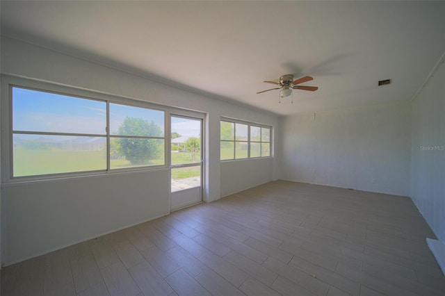 unfurnished room with ceiling fan