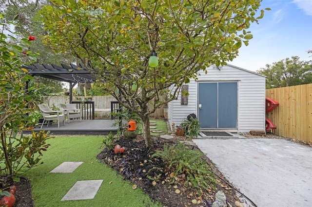 view of yard with a deck, a pergola, a patio, and a shed