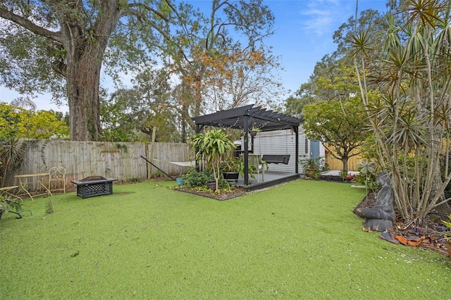 view of yard with a pergola and an outdoor fire pit