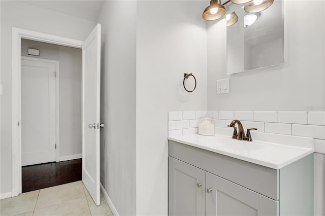 bathroom with decorative backsplash, tile patterned floors, and vanity