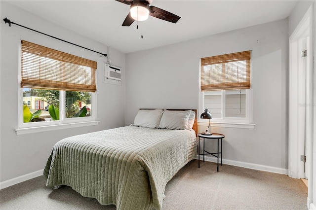 bedroom featuring ceiling fan, a wall mounted AC, and carpet floors