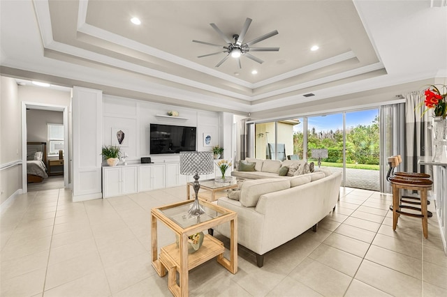 living room featuring recessed lighting, light tile patterned flooring, a raised ceiling, and crown molding