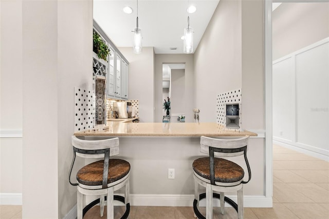 bar featuring hanging light fixtures, light tile patterned floors, and recessed lighting